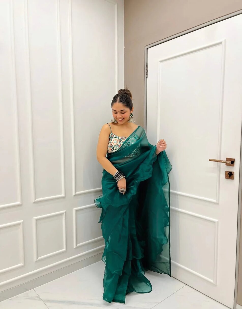Green organza ruffles saree with hand embroidered blouse